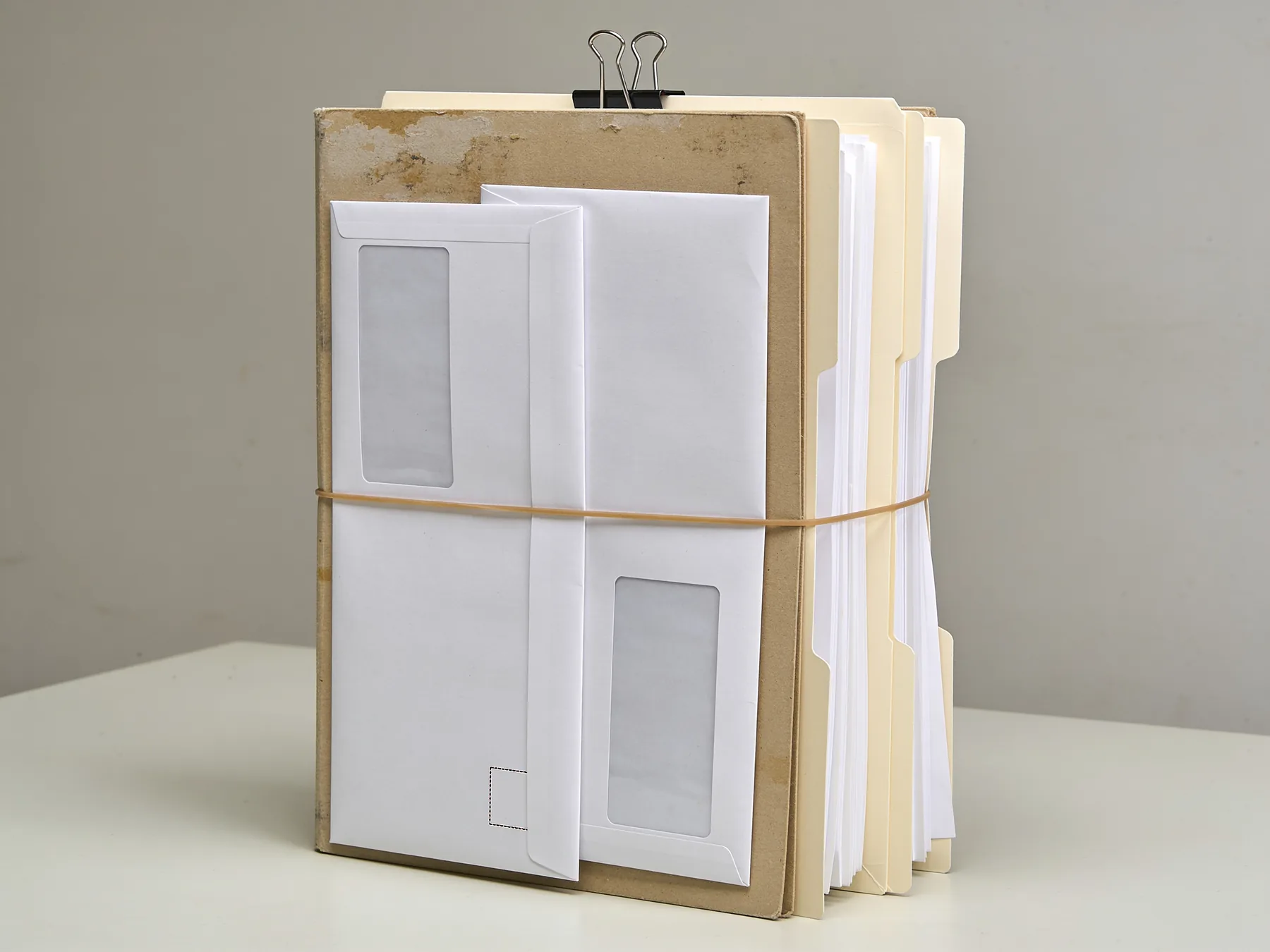 A stack of official documents and folders on a table