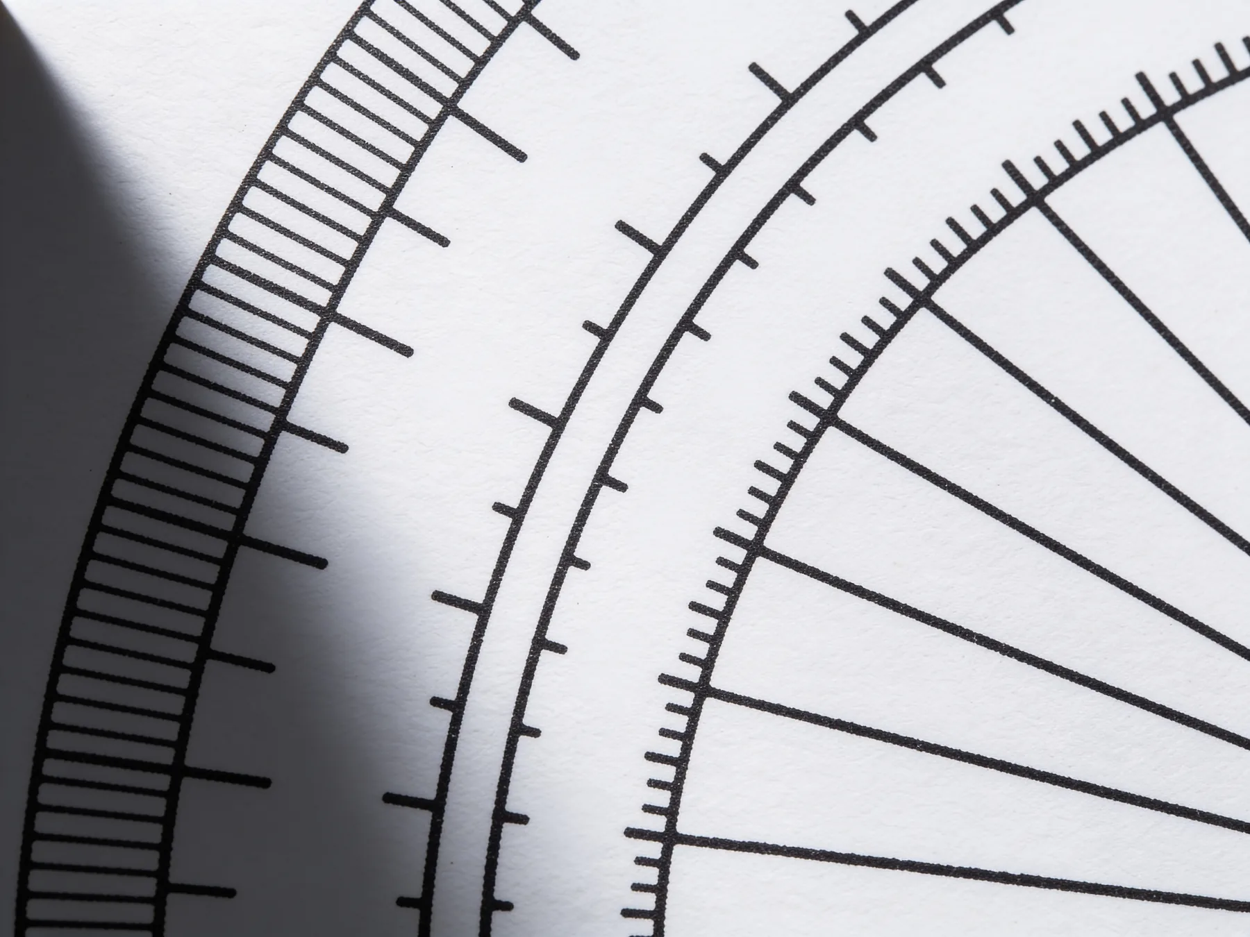 A ruled paper gauge or dial printed on a document, closely cropped
